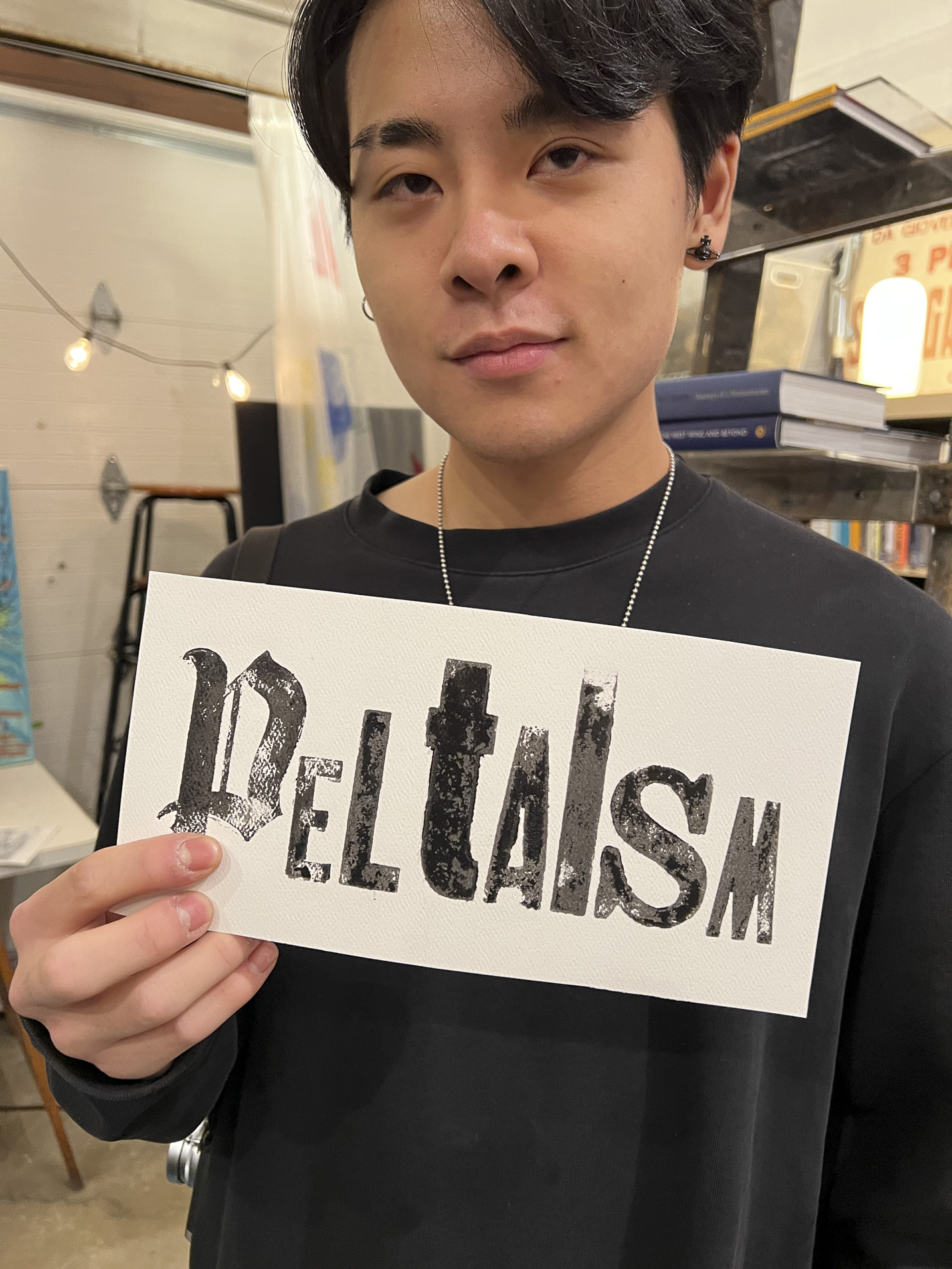 Tisch student holding a print made with hand-set type